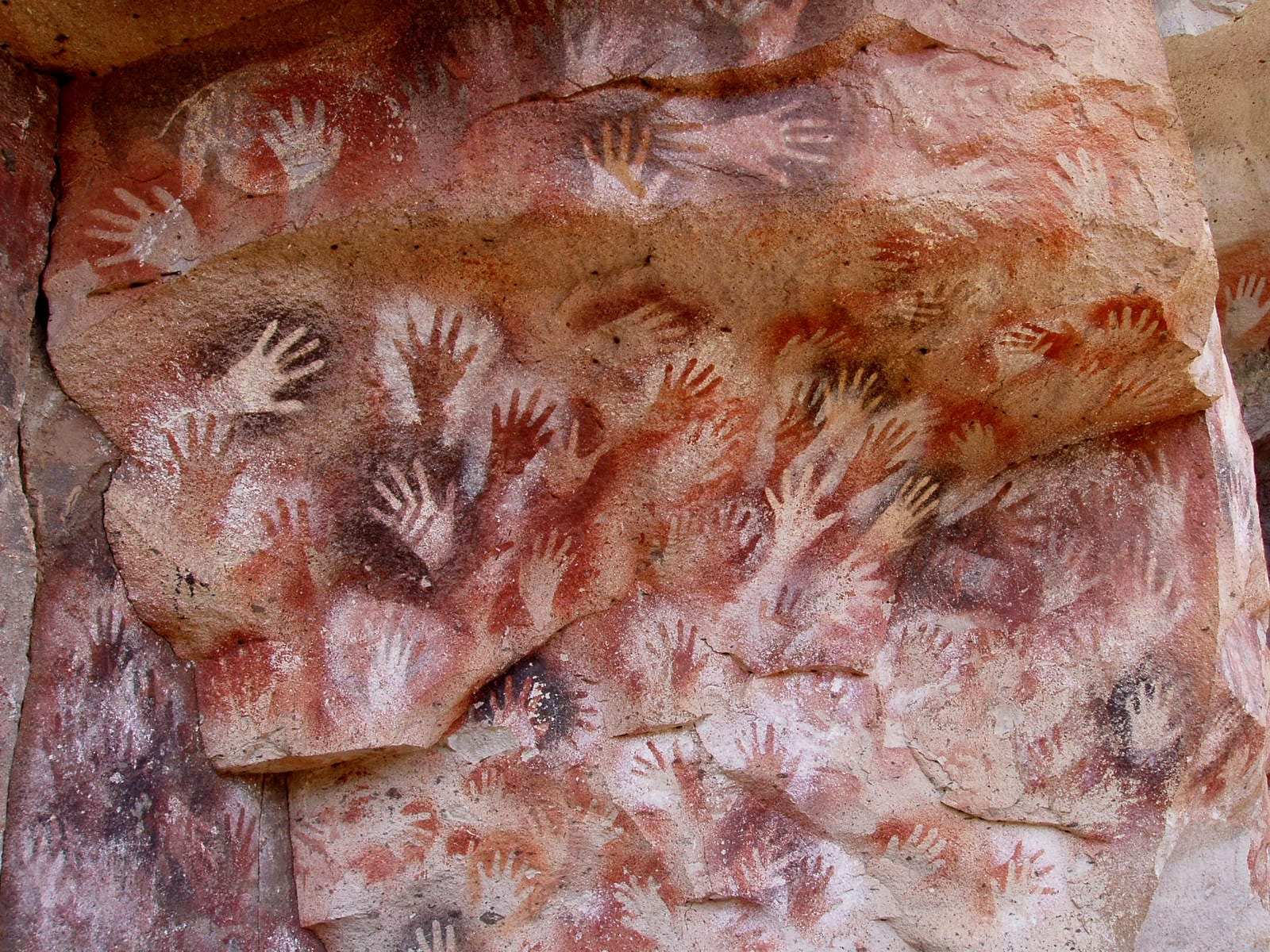 Collaged handprints on the wall of the Cueva de las Manos in Argentina.